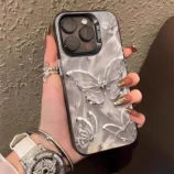 Stunning silver 3D butterfly phone case held gracefully in hand.