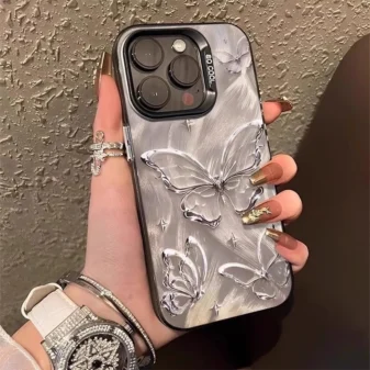 Stunning silver 3D butterfly phone case held gracefully in hand.