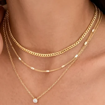 Gold and silver layered zircon pendant necklace worn on neck