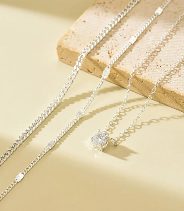gold-and-silver-layered-zircon-pendant-necklace-4 Gold and silver layered zircon pendant necklace silver close-up on stone prop