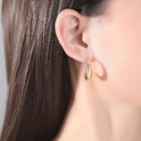 Gold & Silver Geometric Copper Earrings for Women worn elegantly on a model's earlobe