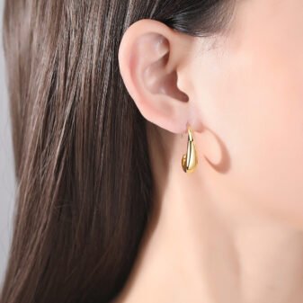 Gold & Silver Geometric Copper Earrings for Women worn elegantly on a model's earlobe
