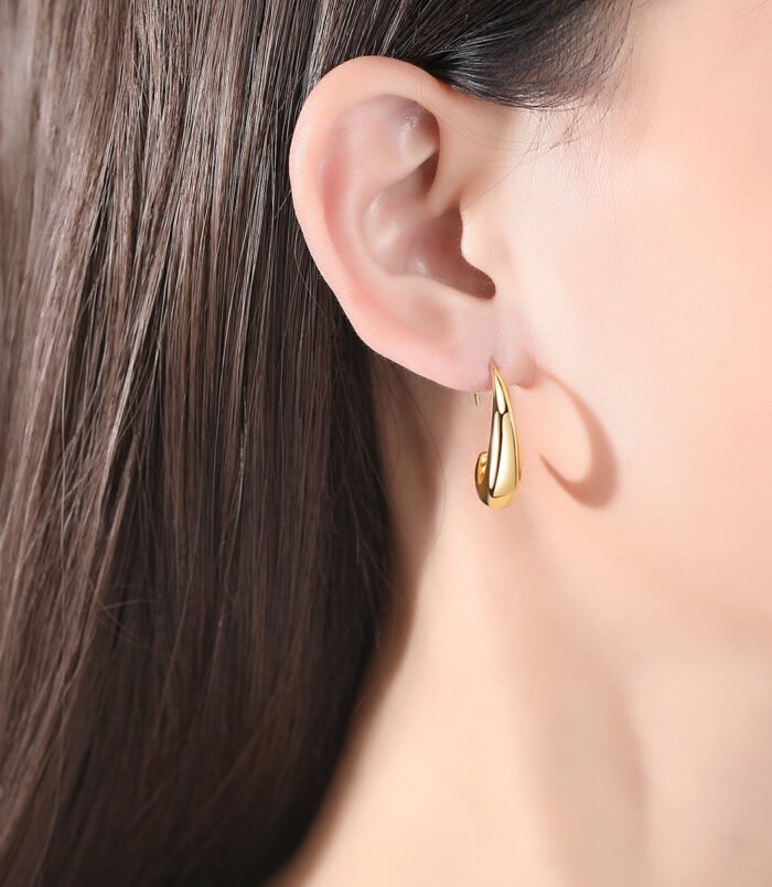 Gold & Silver Geometric Copper Earrings for Women worn elegantly on a model's earlobe