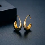 Gold & Silver Geometric Copper Earrings for Women close-up highlighting the polished gold curved surface