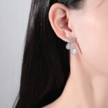 Gold & Silver Zircon Water Drop Earrings worn elegantly on a model's ear.
