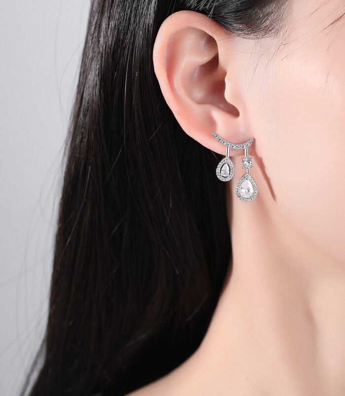 Gold & Silver Zircon Water Drop Earrings worn elegantly on a model's ear.