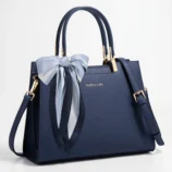 Elegant dark blue PU leather Boston bag with a decorative bow scarf.