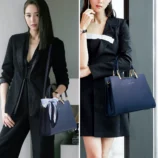Multicolor PU leather Boston bag held by a model wearing stylish office attire.