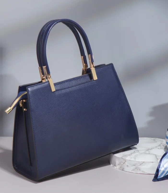 Multicolor PU leather Boston bag back view with the decorative scarf placed beside it.