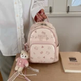Pastel Cat Print PU Leather Backpack for Women held by hand indoors.