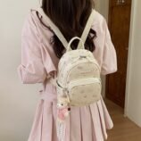 Pastel Cat Print PU Leather Backpack for Women worn casually on the back.