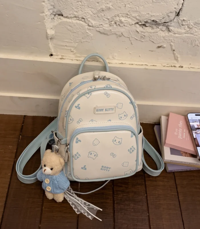 Pastel Cat Print PU Leather Backpack for Women blue style front view.