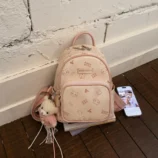 Pastel Cat Print PU Leather Backpack for Women light pink version resting on floor.