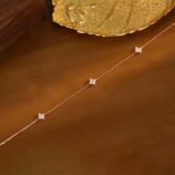 Silver and Gold Minimalist Rhinestone Necklace for Women styled on a warm wooden table near a gold leaf tray.