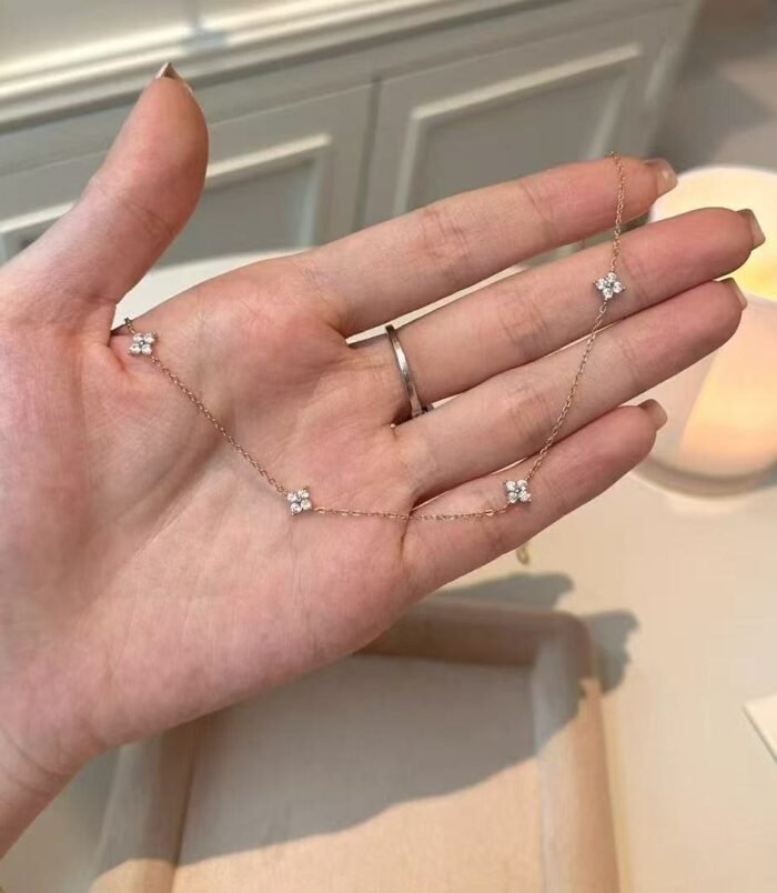 Silver and Gold Minimalist Rhinestone Necklace for Women held elegantly across a hand to show scale.