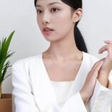 Silver and Gold Minimalist Rhinestone Necklace for Women worn comfortably by a model in a white blazer.