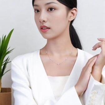 Silver and Gold Minimalist Rhinestone Necklace for Women worn comfortably by a model in a white blazer.