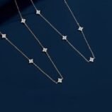 Silver and Gold Minimalist Rhinestone Necklace for Women showcasing multiple chains on a rich dark blue backdrop.