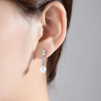 Silver-Plated Zircon Pearl Drop Earrings for Women standing on a dark surface highlighting the shine.