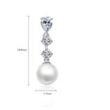 Silver-Plated Zircon Pearl Drop Earrings for Women worn on the ear to show size and fit.