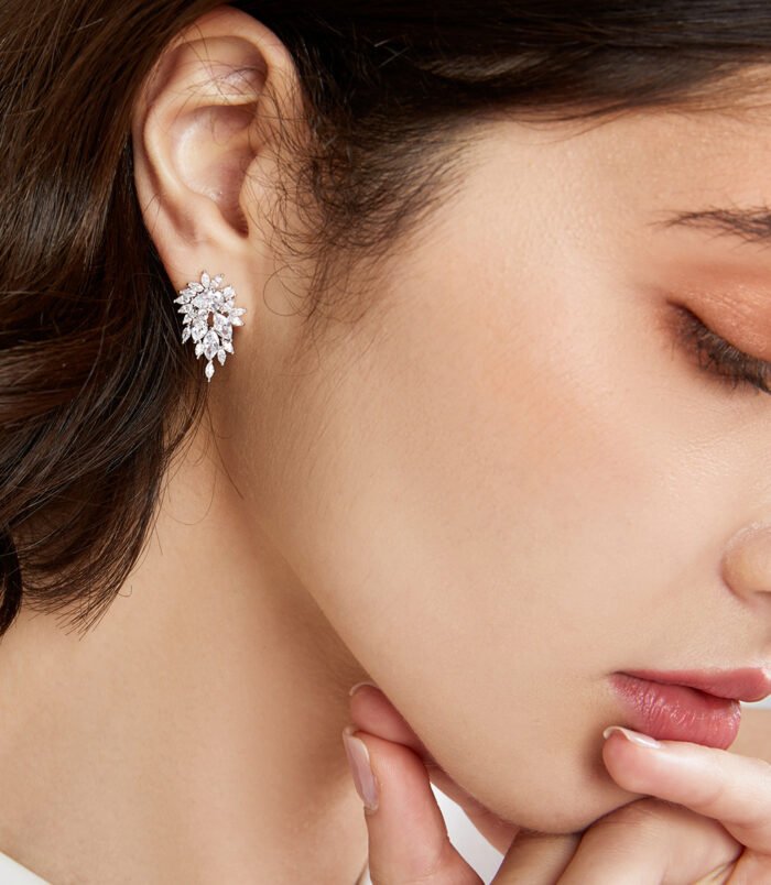 silver-zircon-earrings-women-2 Silver zircon earrings for women resting on a dark display surface