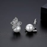 Silver Zircon Pearl Earrings worn on ear by a female model