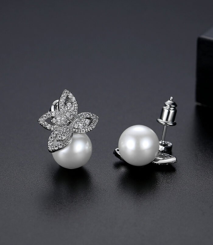 Silver Zircon Pearl Earrings worn on ear by a female model