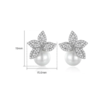 Silver Zircon Pearl Earrings angled close-up view resting on a dark surface
