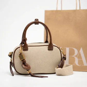 Elegant original white small square crossbody bag with brown trim.