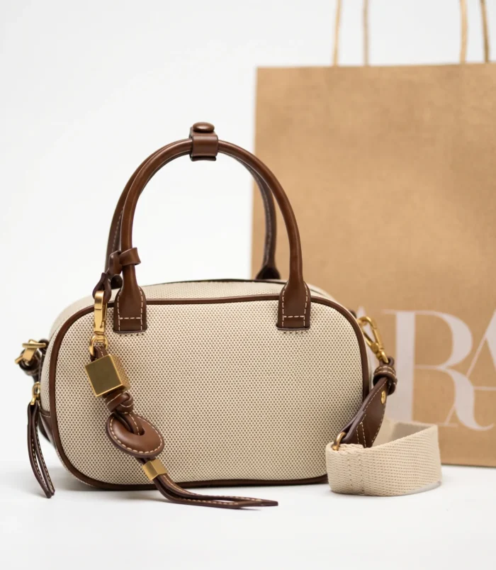 Elegant original white small square crossbody bag with brown trim.