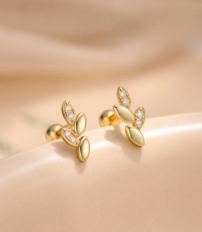 Sterling silver leaf earrings close-up of the gold color showing the screw back closure.