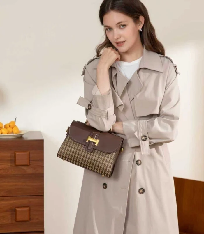 Black and Brown Vintage Houndstooth Handbag for Women - held in front of trench coat.