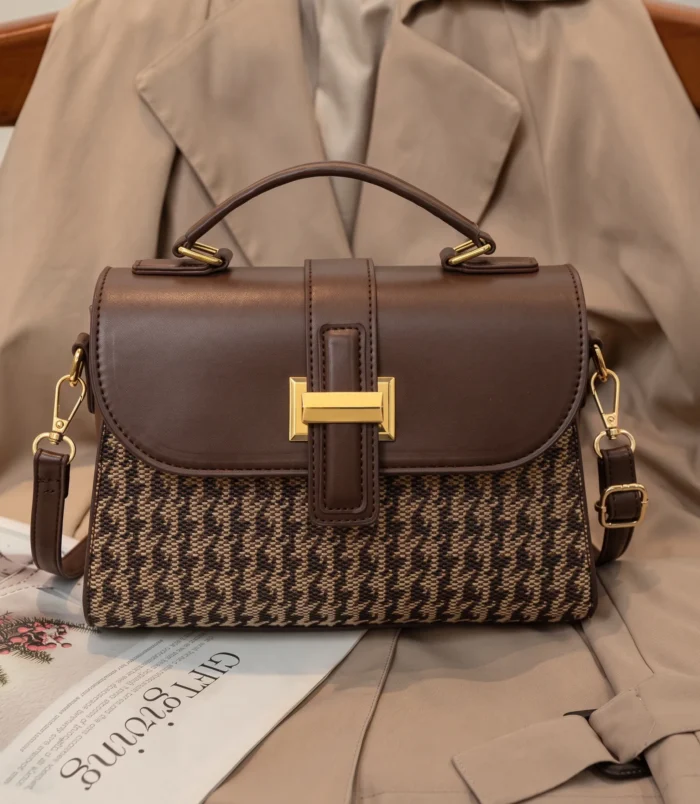 Elegant brown vintage houndstooth handbag with a gold buckle front view.
