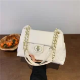 Black & White Quilted PU Shoulder Bag in white held by hand