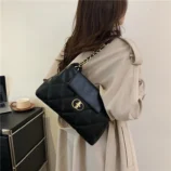 Black & White Quilted PU Shoulder Bag worn on the shoulder by a model