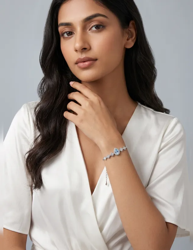 Woman wearing a silver bracelet with a blue teardrop stone