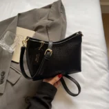 Stylish black casual PU leather hobo bag held gracefully by hand