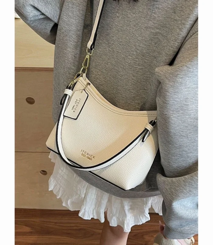 White crossbody bag worn comfortably over the shoulder with casual attire