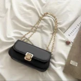 Classic PU Leather Underarm Bag for Women in black resting on a bed
