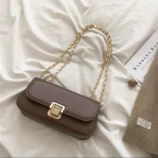Classic PU Leather Underarm Bag for Women in brown styled with a book