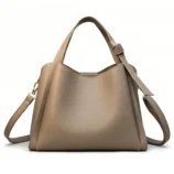 Beautiful khaki small PU leather tote front view showing top handles and strap.