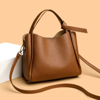 Classic Soft PU Leather Tote Bag for Women in brown resting on a display block.