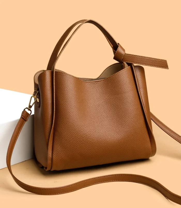 Classic Soft PU Leather Tote Bag for Women in brown resting on a display block.