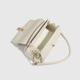 Cream White PU Leather Shoulder Bag for Women angled front view showing strap details.