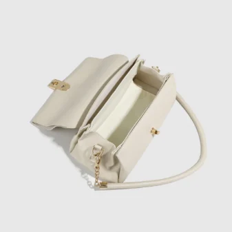 Cream White PU Leather Shoulder Bag for Women angled front view showing strap details.