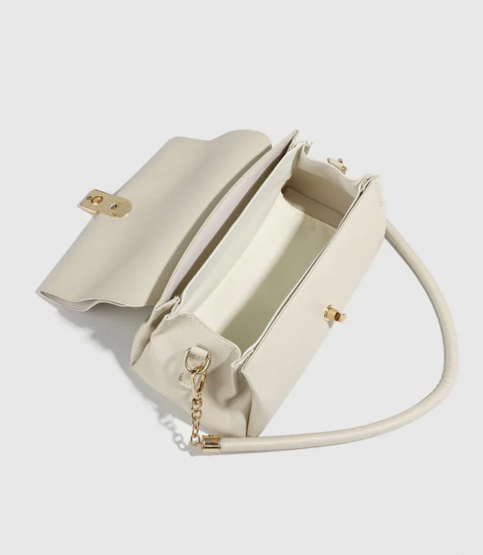 Cream White PU Leather Shoulder Bag for Women angled front view showing strap details.