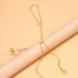 Elegant zircon flower finger bracelet styled elegantly over a beige display roll.