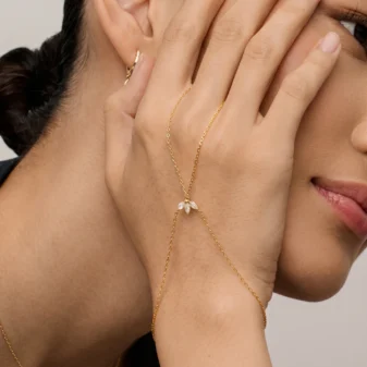 Elegant gold leaf finger bracelet worn gracefully on a woman's hand.