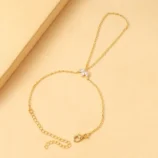 Gold and Silver Rhinestone Leaf Finger Bracelet for Women viewed from an angle with the lobster clasp open.