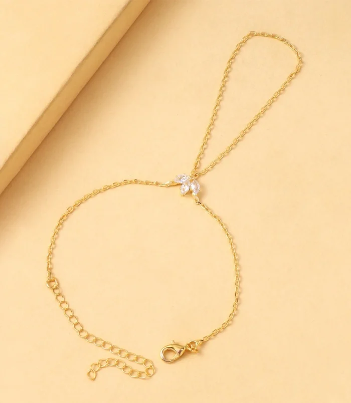 Gold and Silver Rhinestone Leaf Finger Bracelet for Women viewed from an angle with the lobster clasp open.